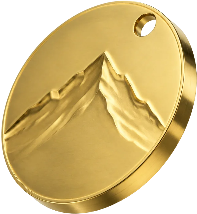 A brass token with an embossed mountain