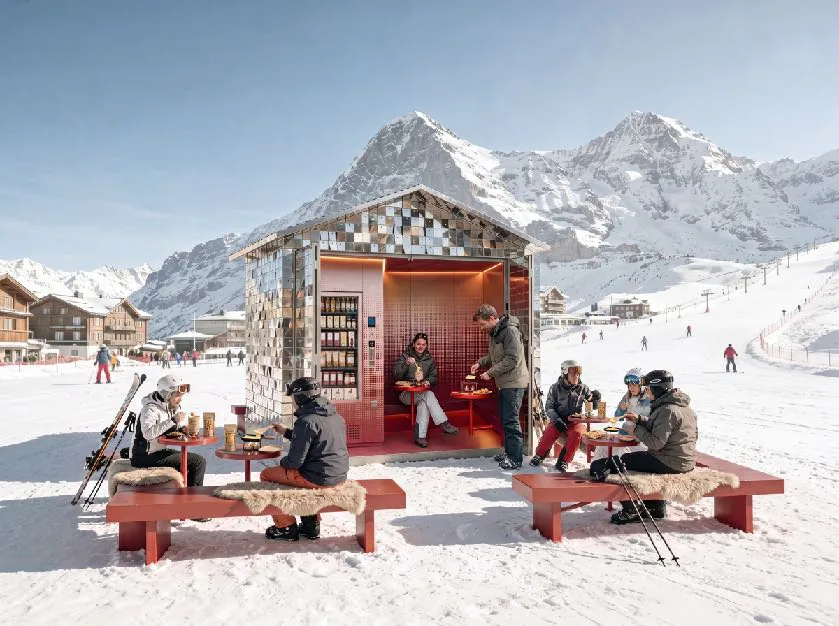Skiers rest on red benches next to a mirrored pavilion on a snowy slope